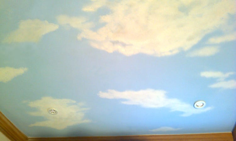 A realistic painting of clouds transforms a ceiling
